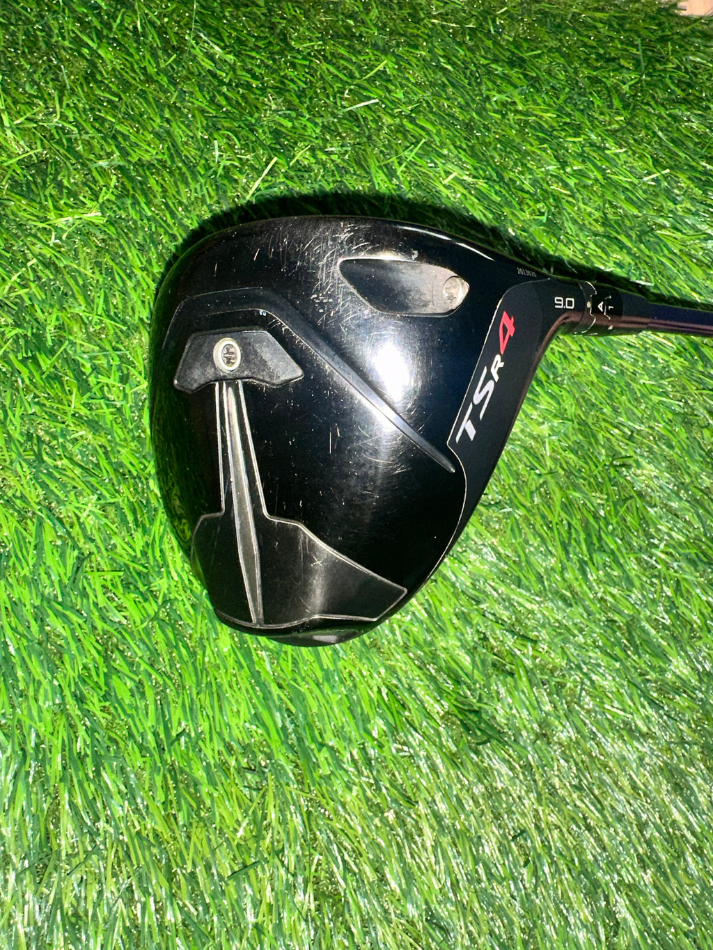 Golf club head with 'TSR4' branding on a grass background